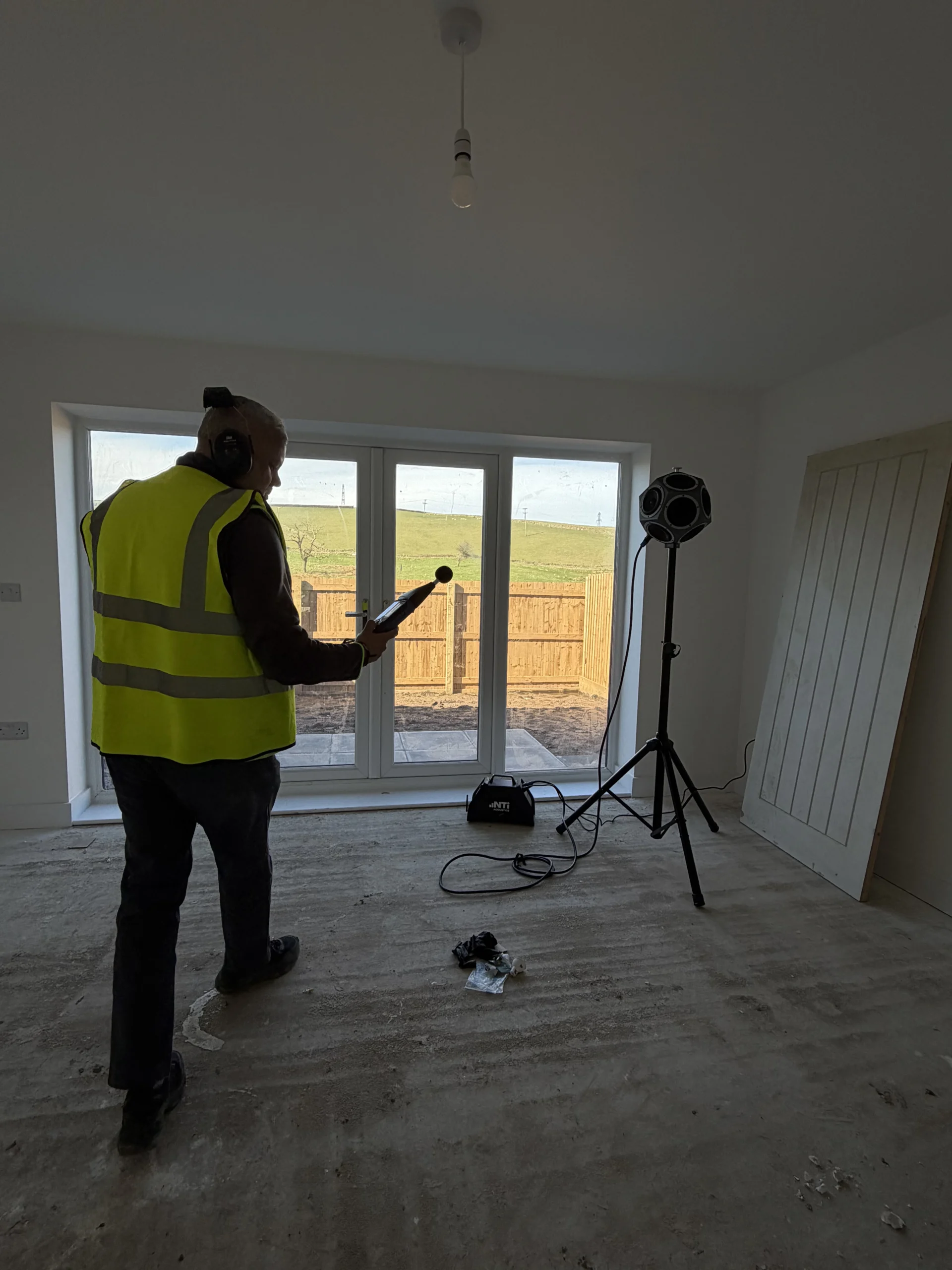 Garmesh Chand of GC Reports conducting on-site sound tests for Building Regulations Part E compliance in a new-build residential property