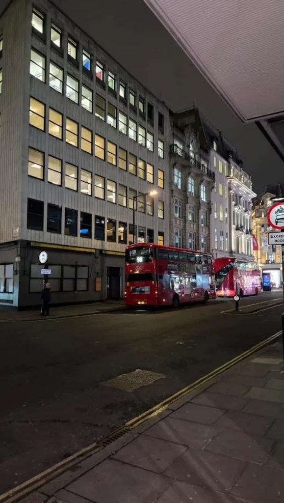 GC Reports' operational reach: A London street scene at night featuring office developments requiring SAP and acoustic compliance