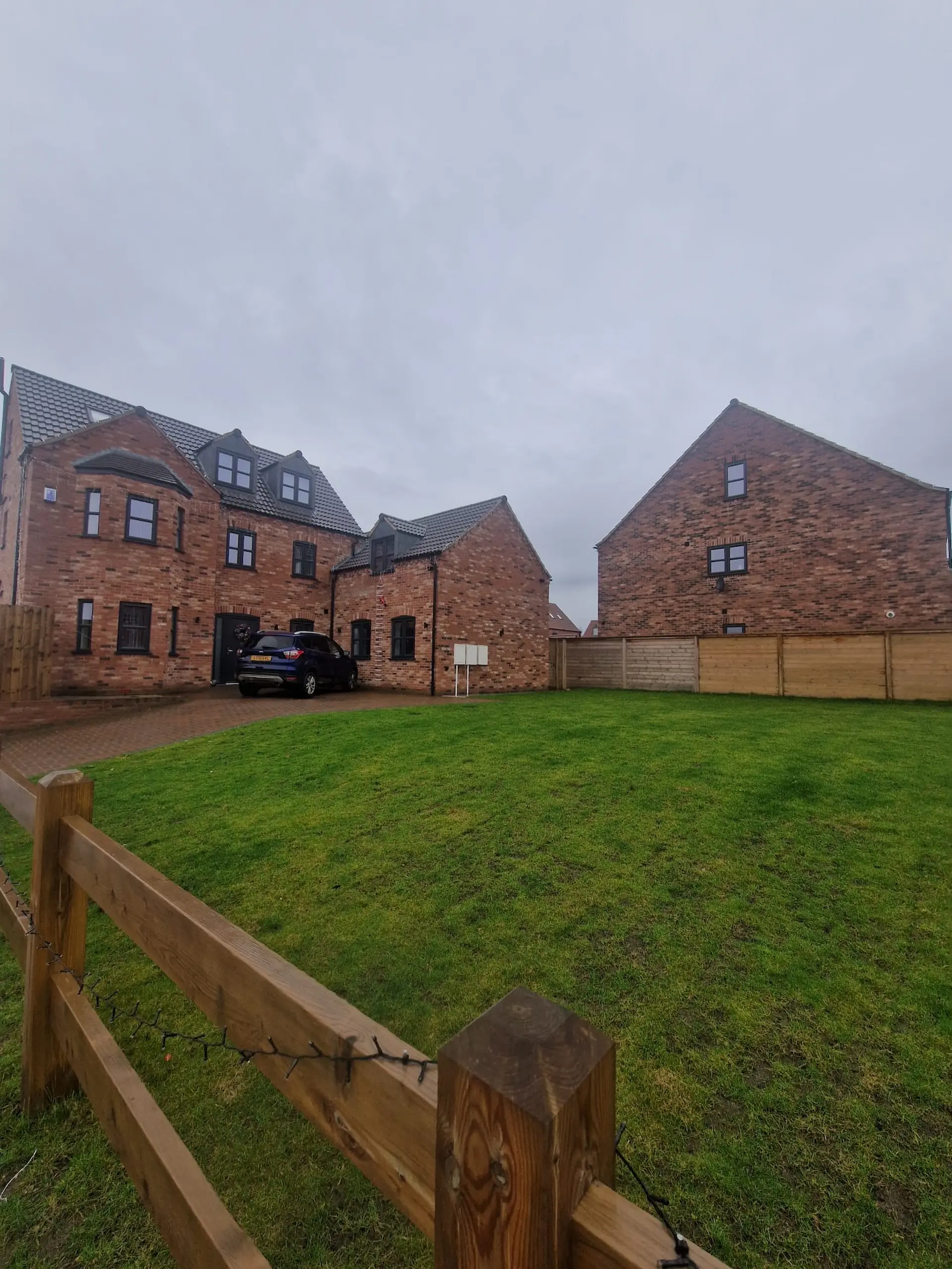 Exterior view of the 7 Lakes housing development by Wroot Homes, featuring new-build brick properties compliant with SAP calculation energy standards