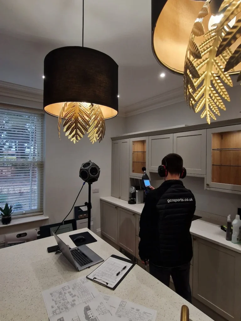 Professional sound insulation testing in progress by GC Reports at the Copper Beech Court development, featuring acoustic measurement equipment and on-site analysis